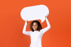 Young African American woman holding empty speech bubble